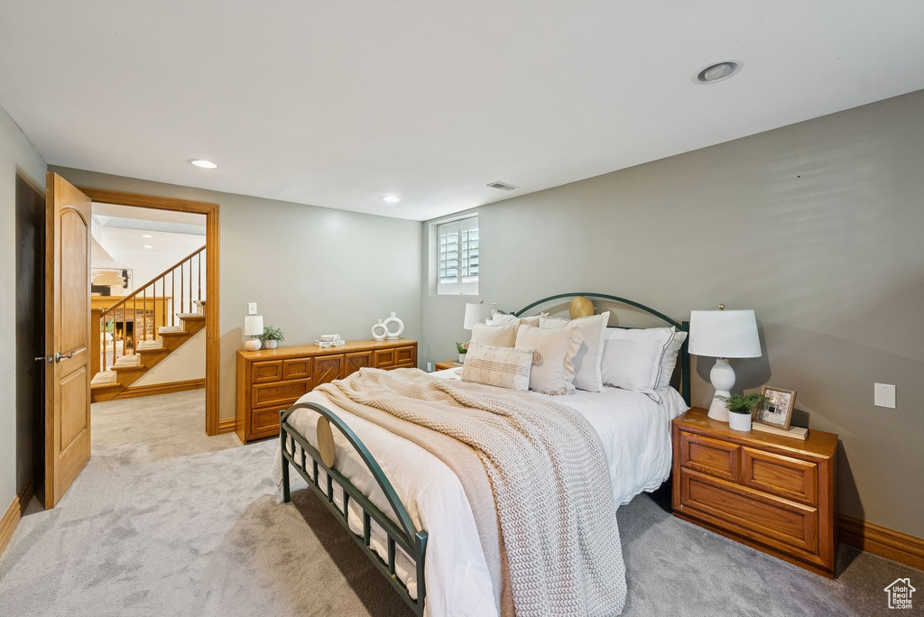 Bedroom with light carpet and recessed lighting