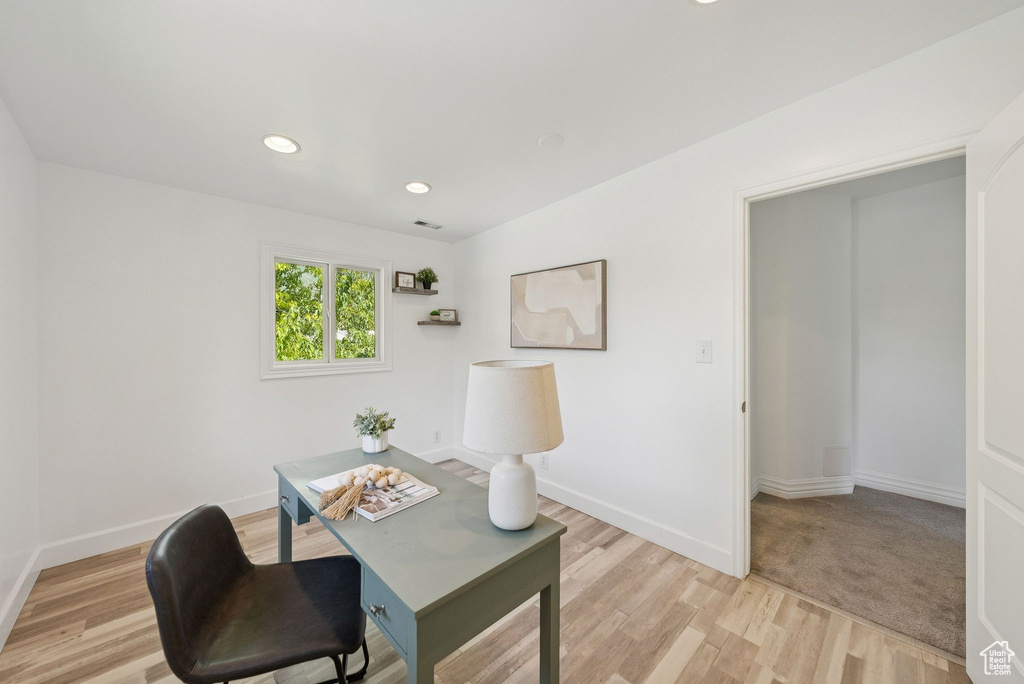 Office area featuring light wood finished floors and recessed lighting