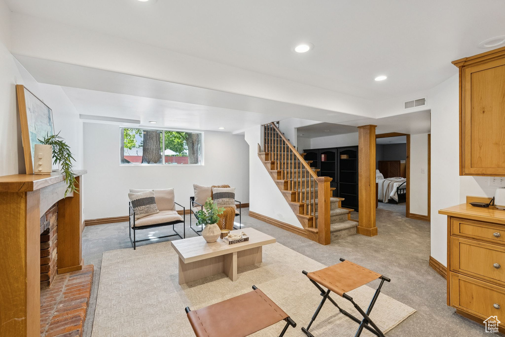 Living area with stairs, a fireplace, and recessed lighting