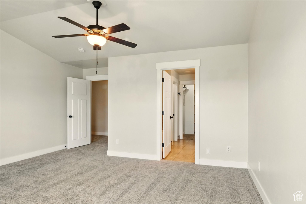 Unfurnished bedroom featuring carpet flooring and a ceiling fan