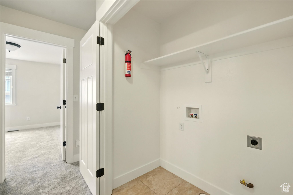 Laundry room with hookup for a washing machine and electric dryer hookup
