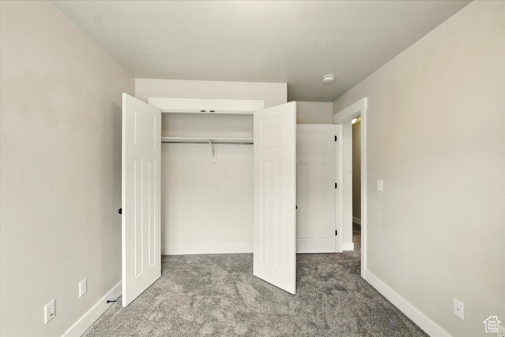 Unfurnished bedroom with carpet flooring and a closet