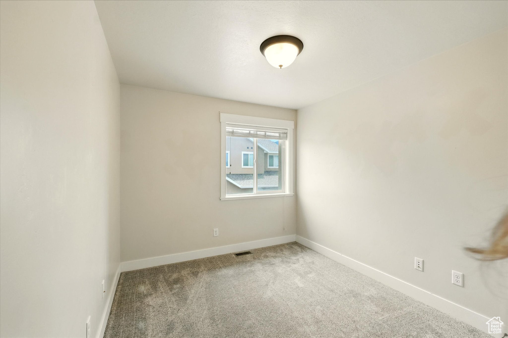 Unfurnished room featuring carpet flooring and baseboards
