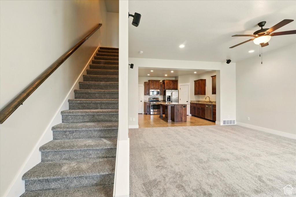 Stairs featuring carpet floors, ceiling fan, and recessed lighting