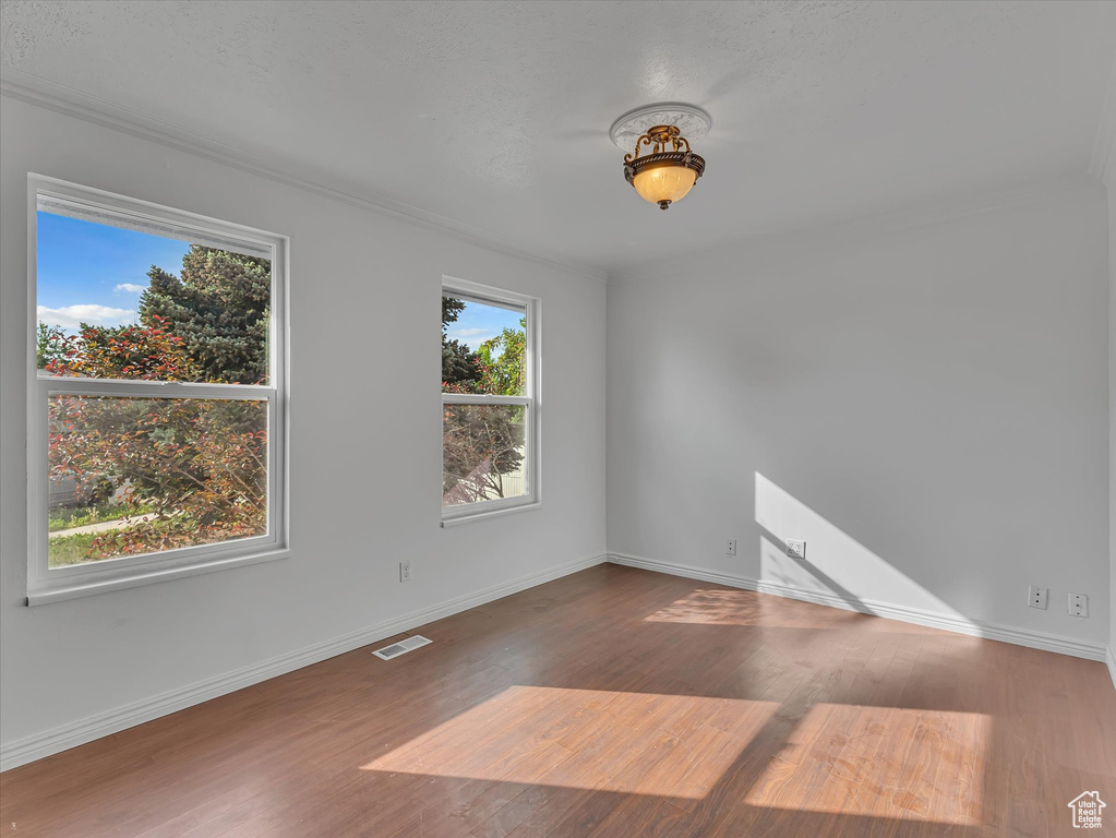 Empty room with wood finished floors and baseboards