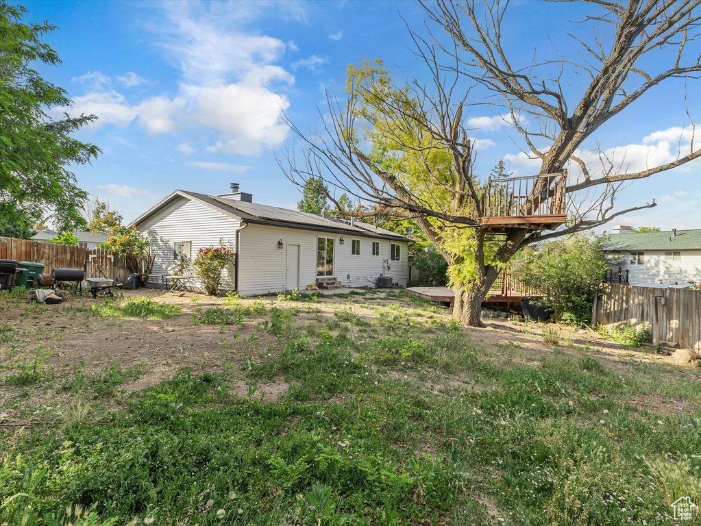 Fenced backyard featuring a wooden deck