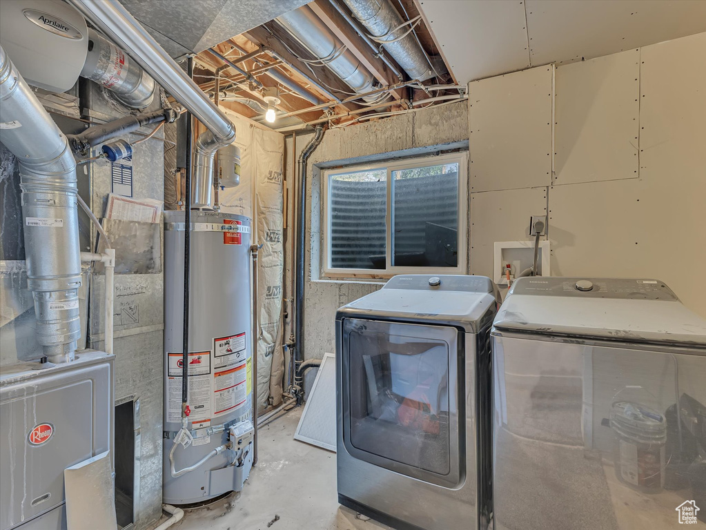 Laundry area with water heater and independent washer and dryer