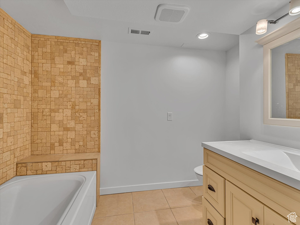 Bathroom featuring tile patterned floors, vanity, and recessed lighting