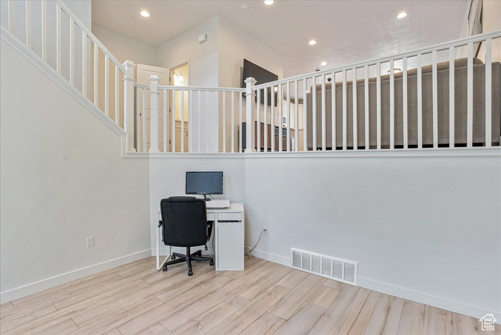 Unfurnished office with wood finished floors and recessed lighting