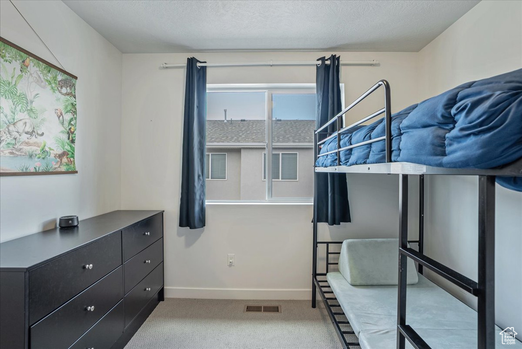 Carpeted bedroom featuring baseboards