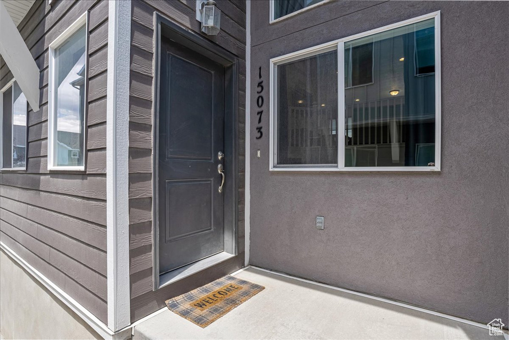 Doorway to property with stucco siding