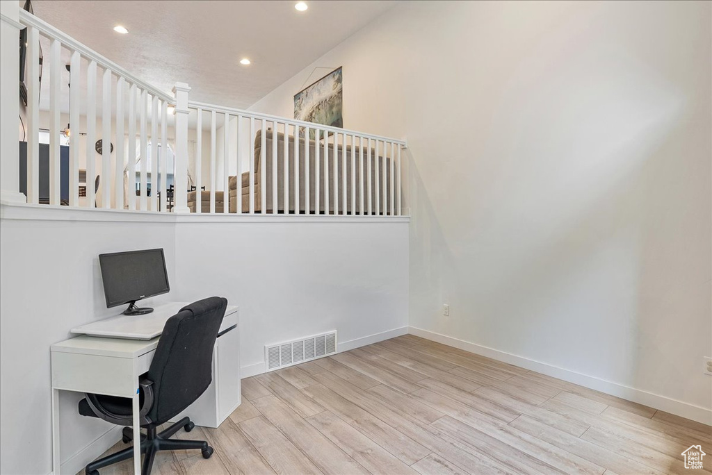 Unfurnished office featuring wood finished floors and recessed lighting