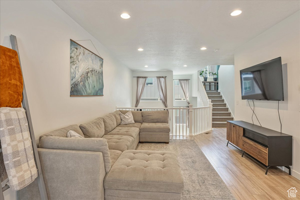 Living area featuring light wood-style floors and recessed lighting