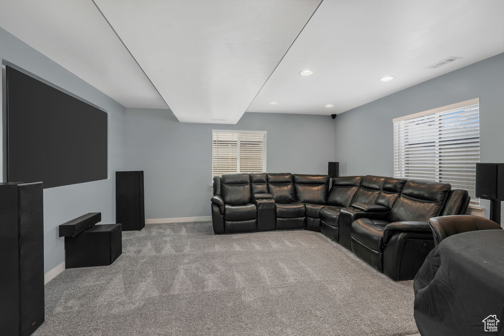Carpeted living area featuring baseboards and recessed lighting