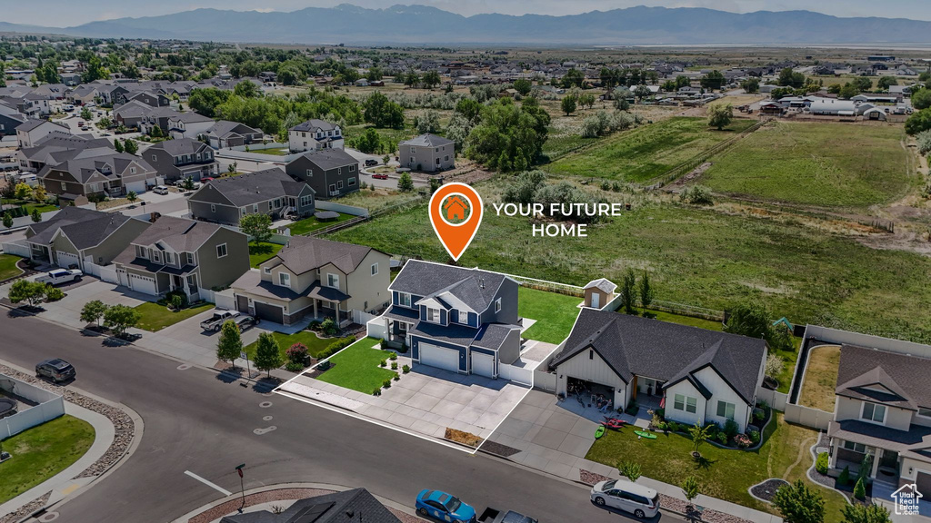 Aerial view of residential area featuring a mountainous background