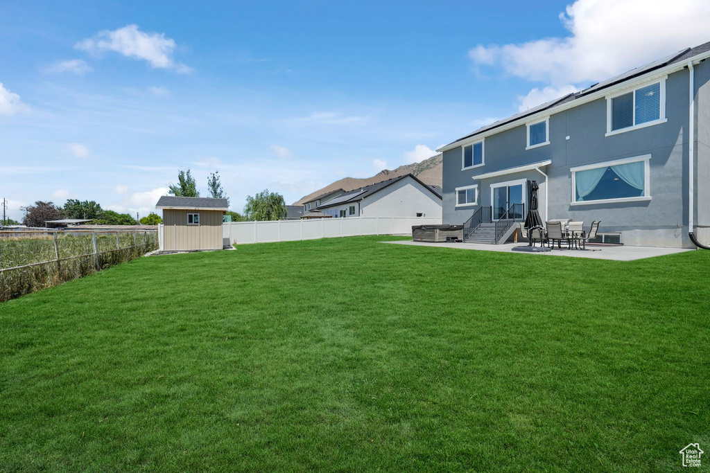 Back of property with a patio area and stucco siding