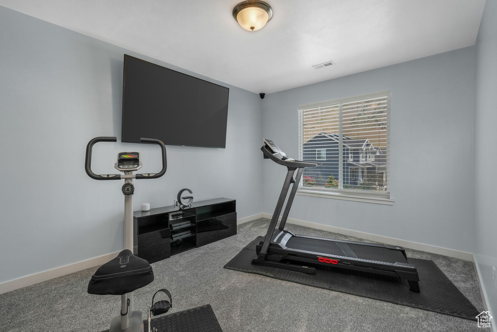 Workout room with carpet floors and baseboards
