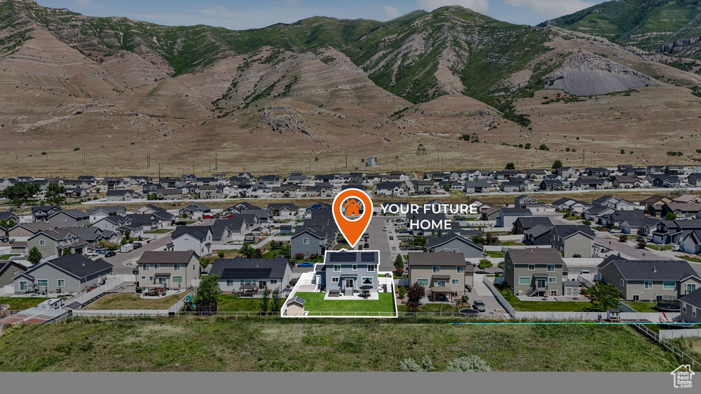 Aerial view of residential area with a mountain backdrop and property parcel outlined