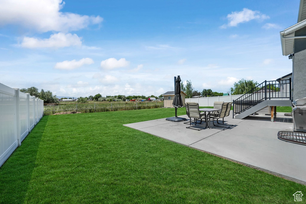 View of yard featuring a patio and stairway