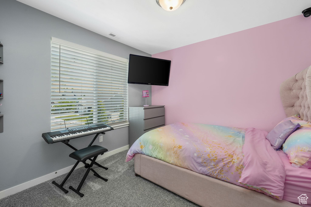 Bedroom with carpet flooring and baseboards