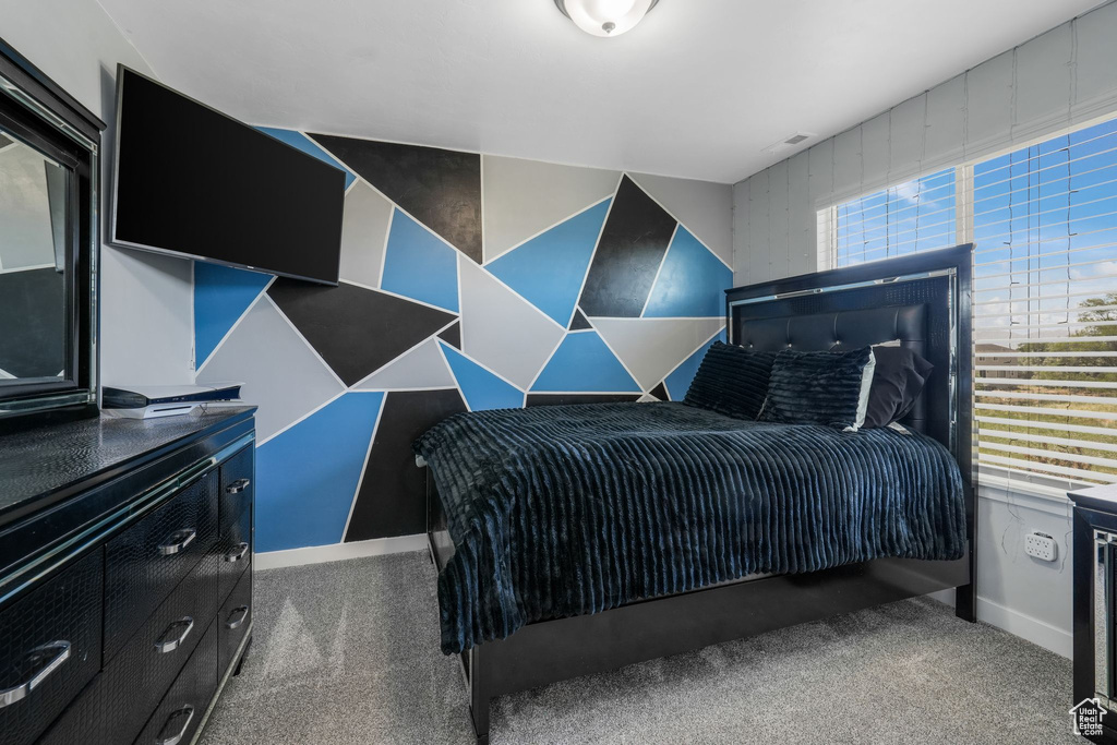 Carpeted bedroom featuring baseboards