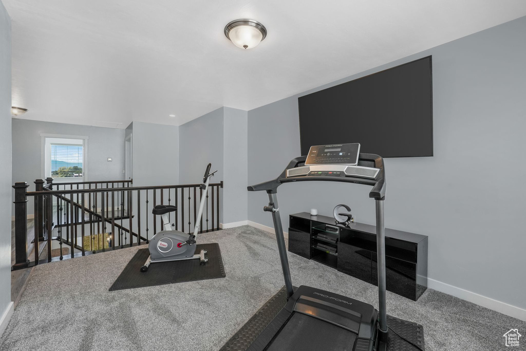 Workout area featuring carpet floors and baseboards
