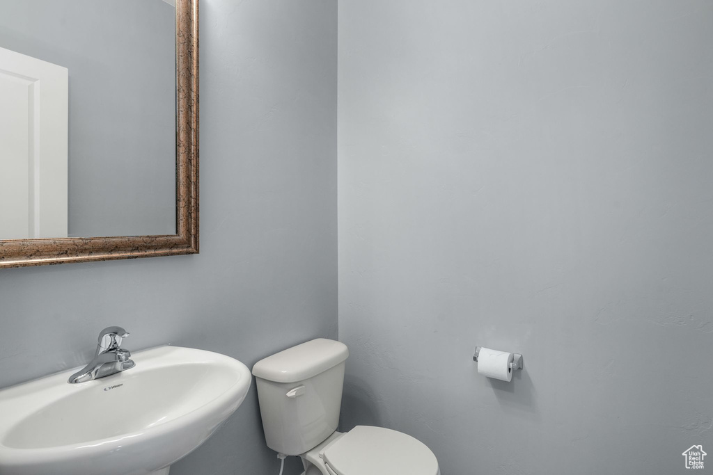 Half bath with a sink and toilet