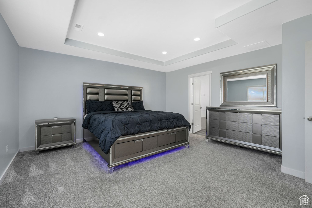 Bedroom with carpet, a tray ceiling, baseboards, and recessed lighting