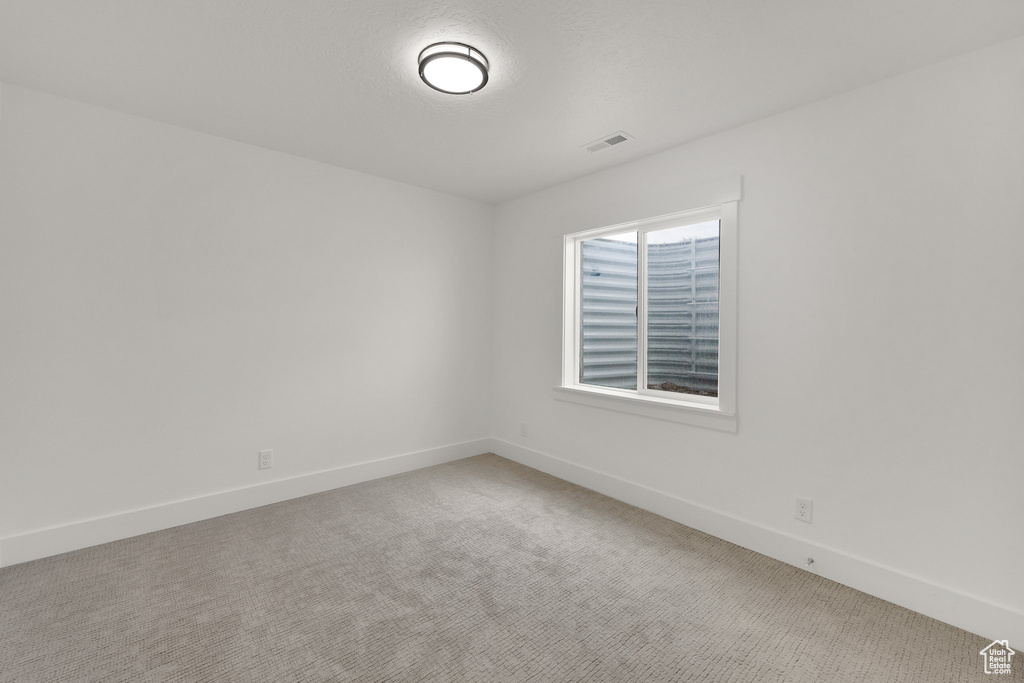 Unfurnished room with carpet and baseboards