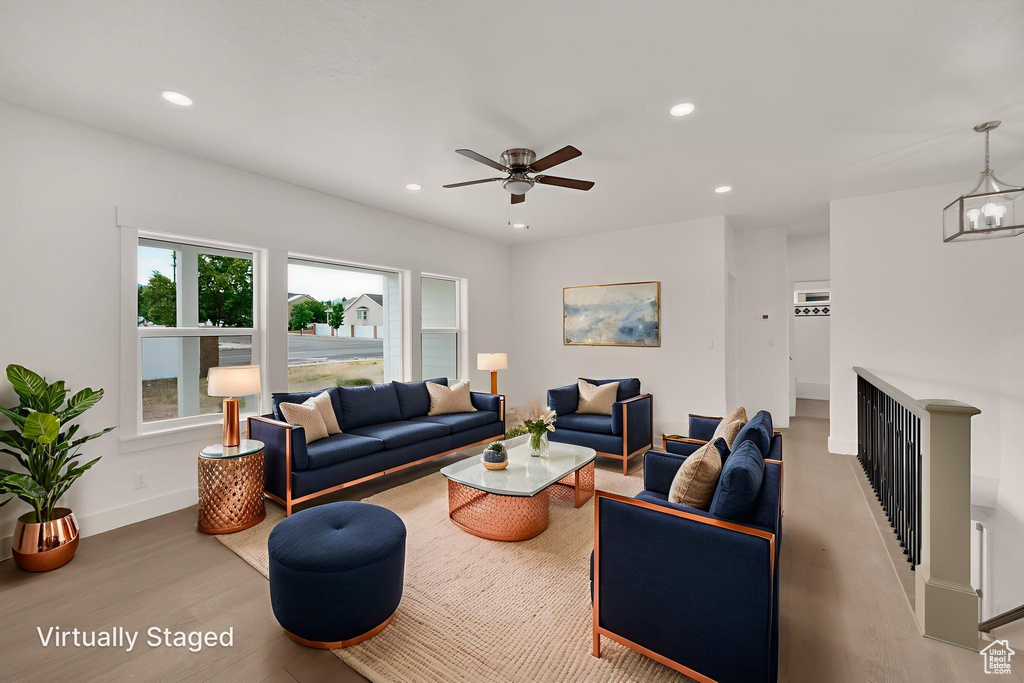 Living area featuring wood finished floors, recessed lighting, and a ceiling fan