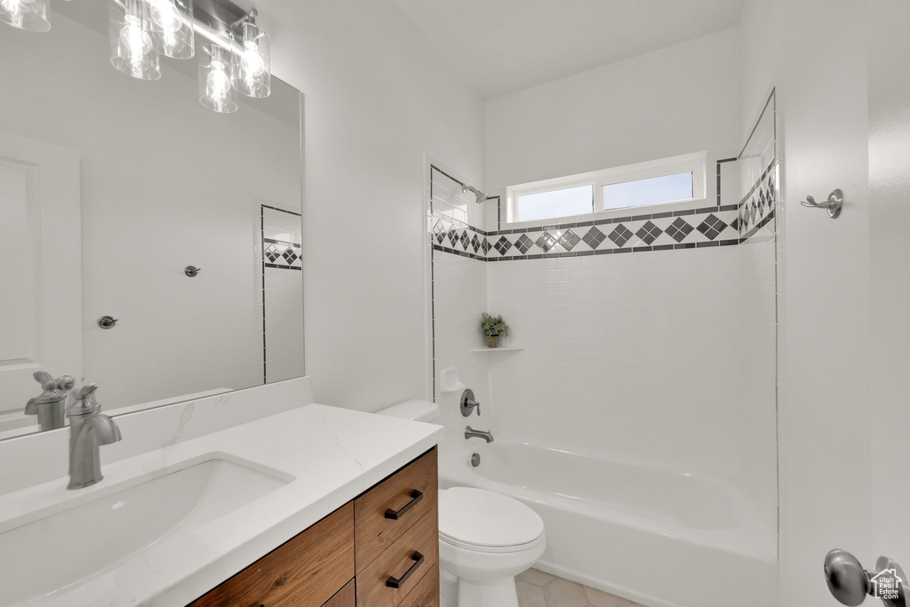 Full bath featuring shower / washtub combination, vanity, and tile patterned flooring