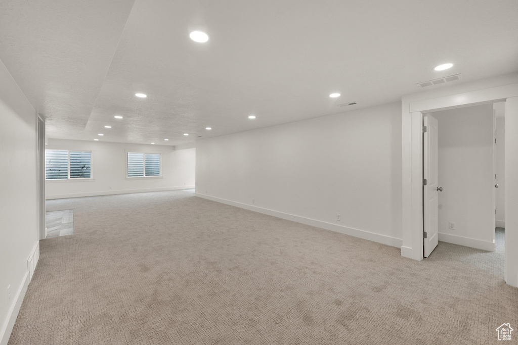 Empty room featuring recessed lighting and light carpet