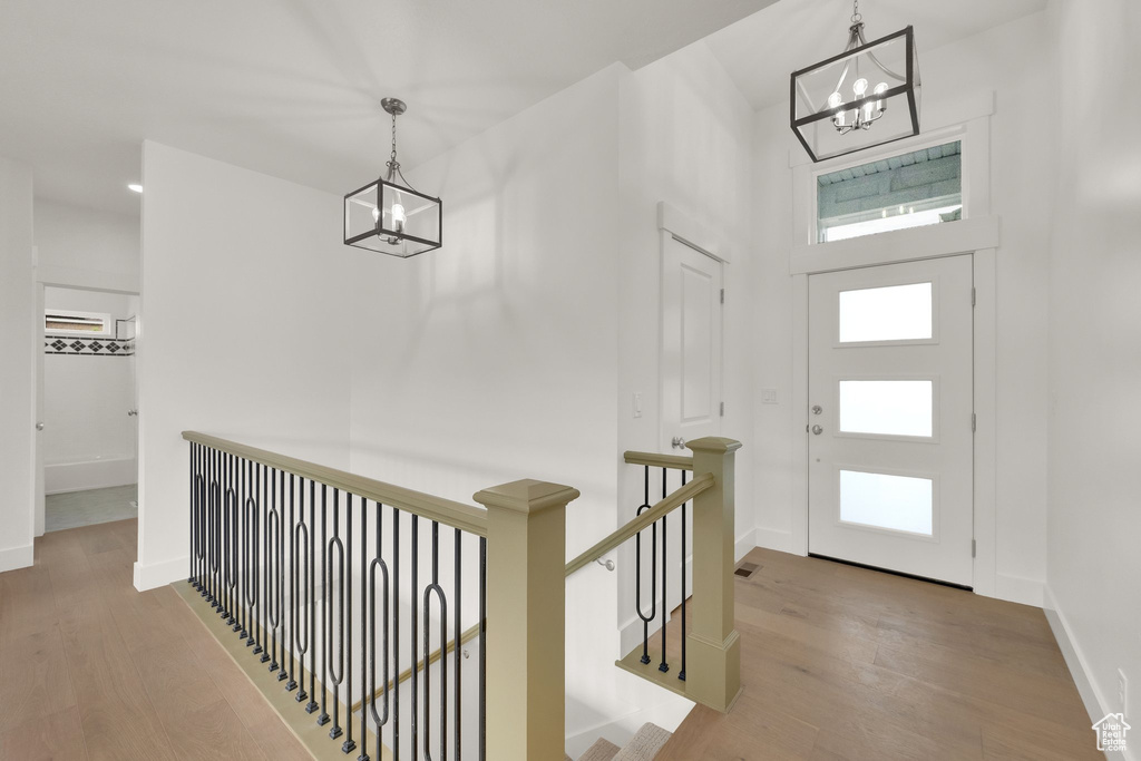 Foyer with a chandelier and wood finished floors