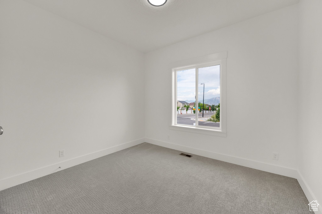 Spare room with light colored carpet