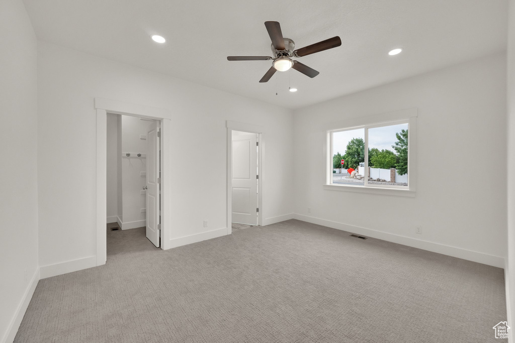 Unfurnished bedroom featuring carpet floors, recessed lighting, and a ceiling fan