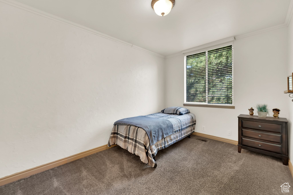 Carpeted bedroom featuring ornamental molding