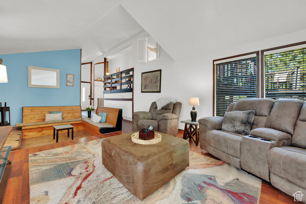 Living room featuring vaulted ceiling and wood finished floors