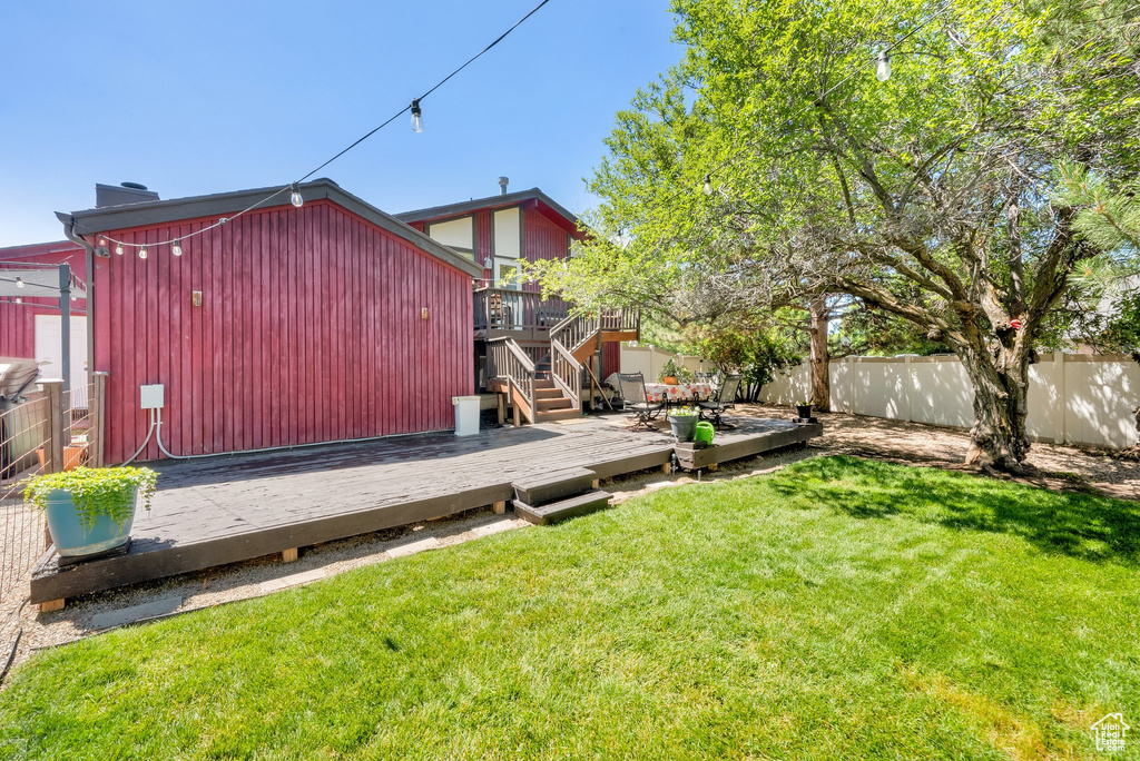 Fenced backyard with a wooden deck and stairway