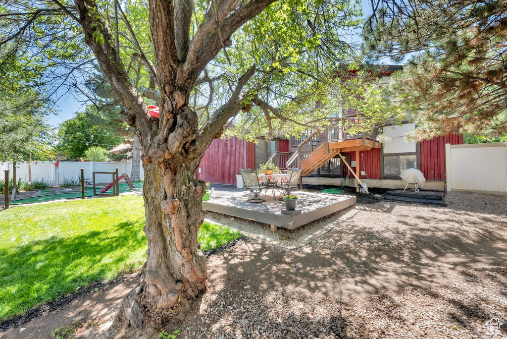 View of yard with a deck and stairs