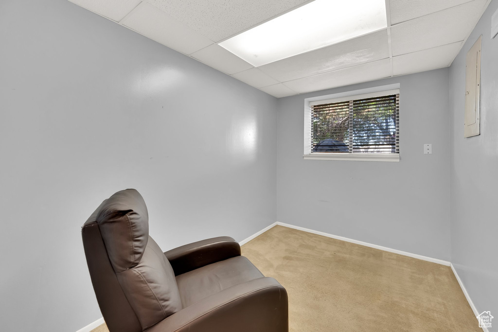 Sitting room featuring a paneled ceiling and carpet