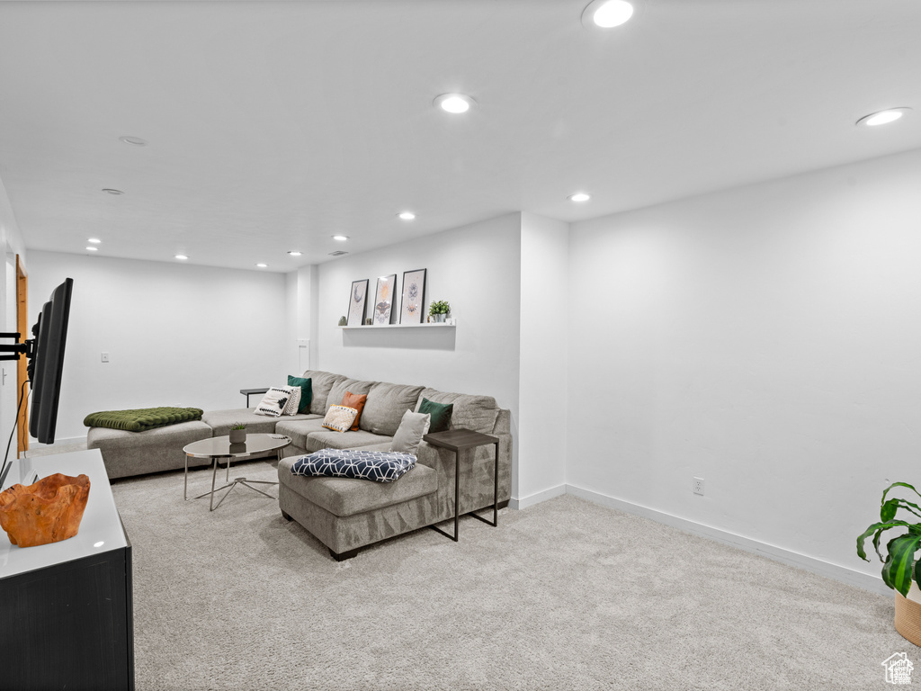 Carpeted living room featuring recessed lighting and baseboards