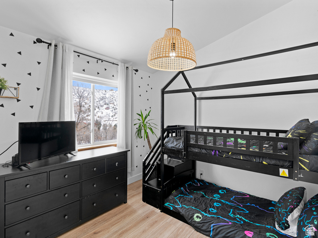 Bedroom featuring light wood finished floors and baseboards