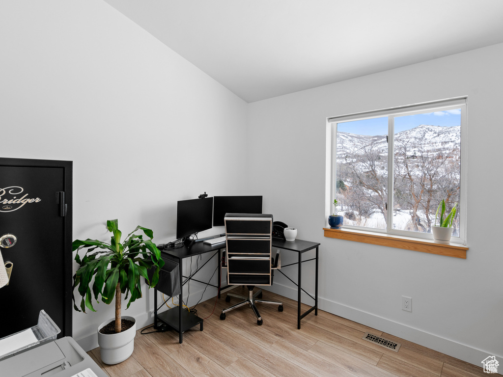 Office space with wood finished floors and baseboards