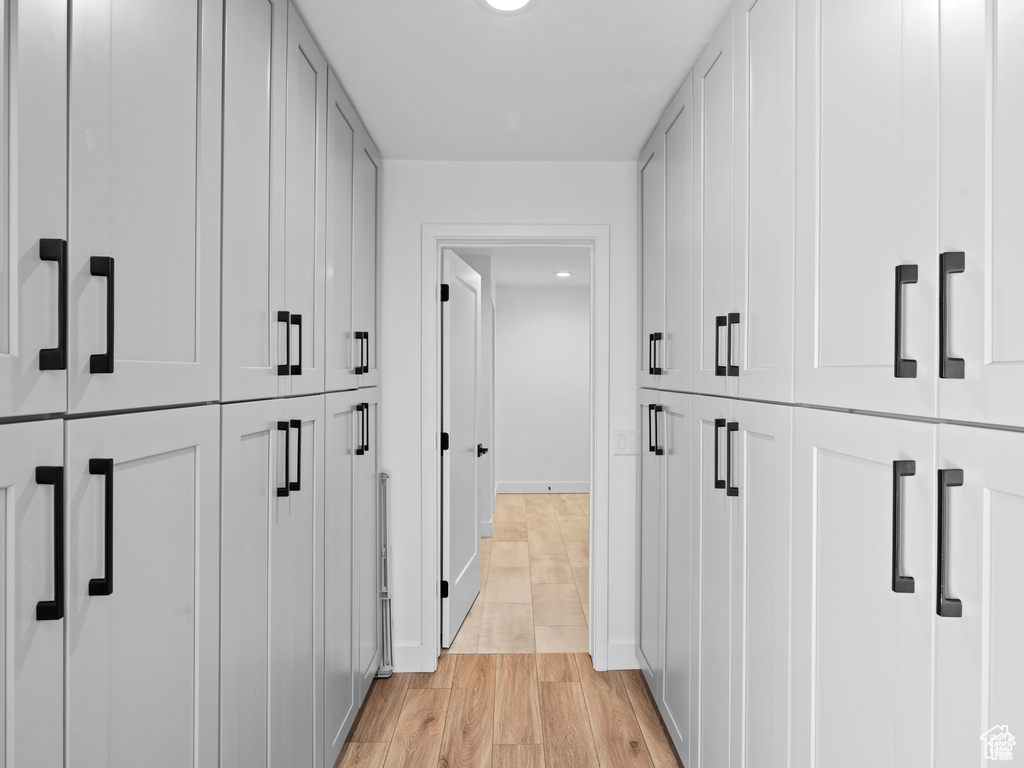 Hall featuring light wood-style floors and baseboards