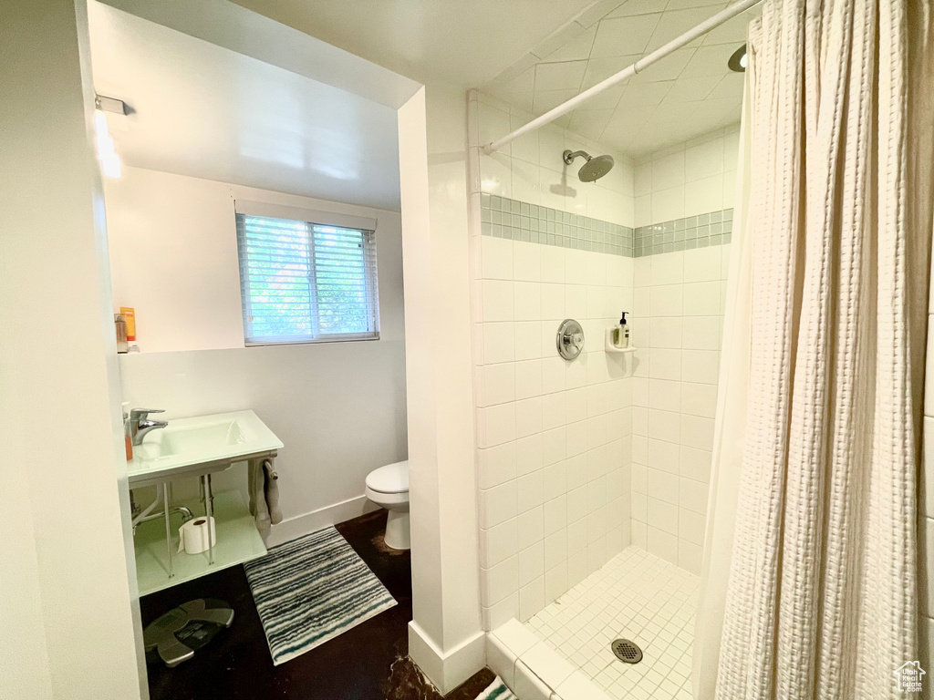 Bathroom featuring toilet and a stall shower