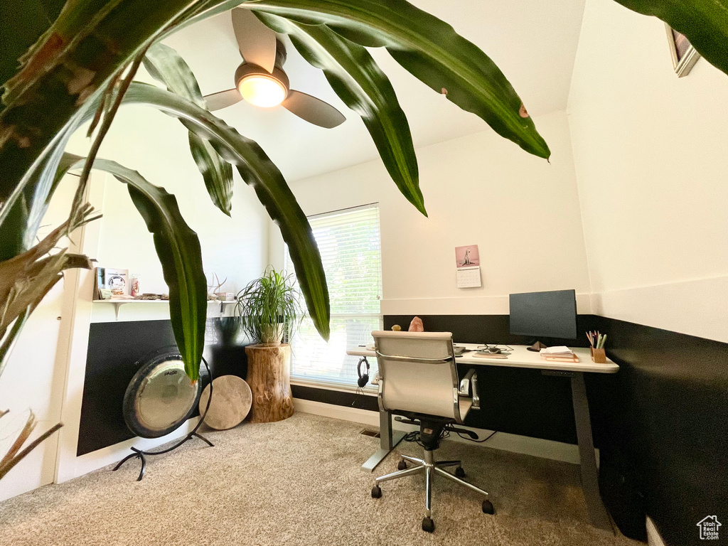 Carpeted home office with ceiling fan and baseboards