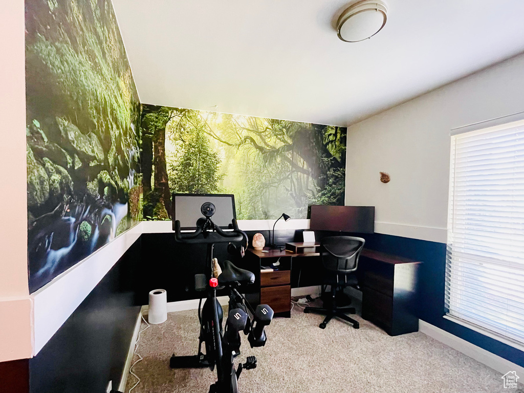 Carpeted home office featuring baseboards