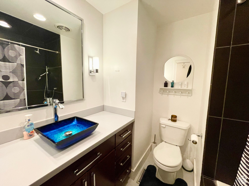 Full bath featuring vanity and curtained shower