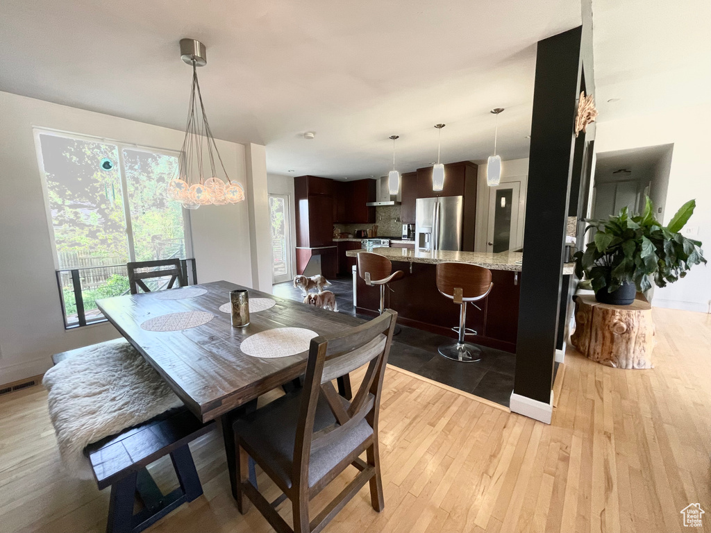 Dining room with light wood-type flooring and baseboards