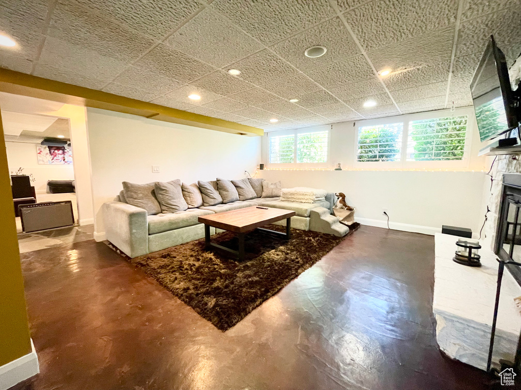 Living area featuring recessed lighting and finished concrete flooring